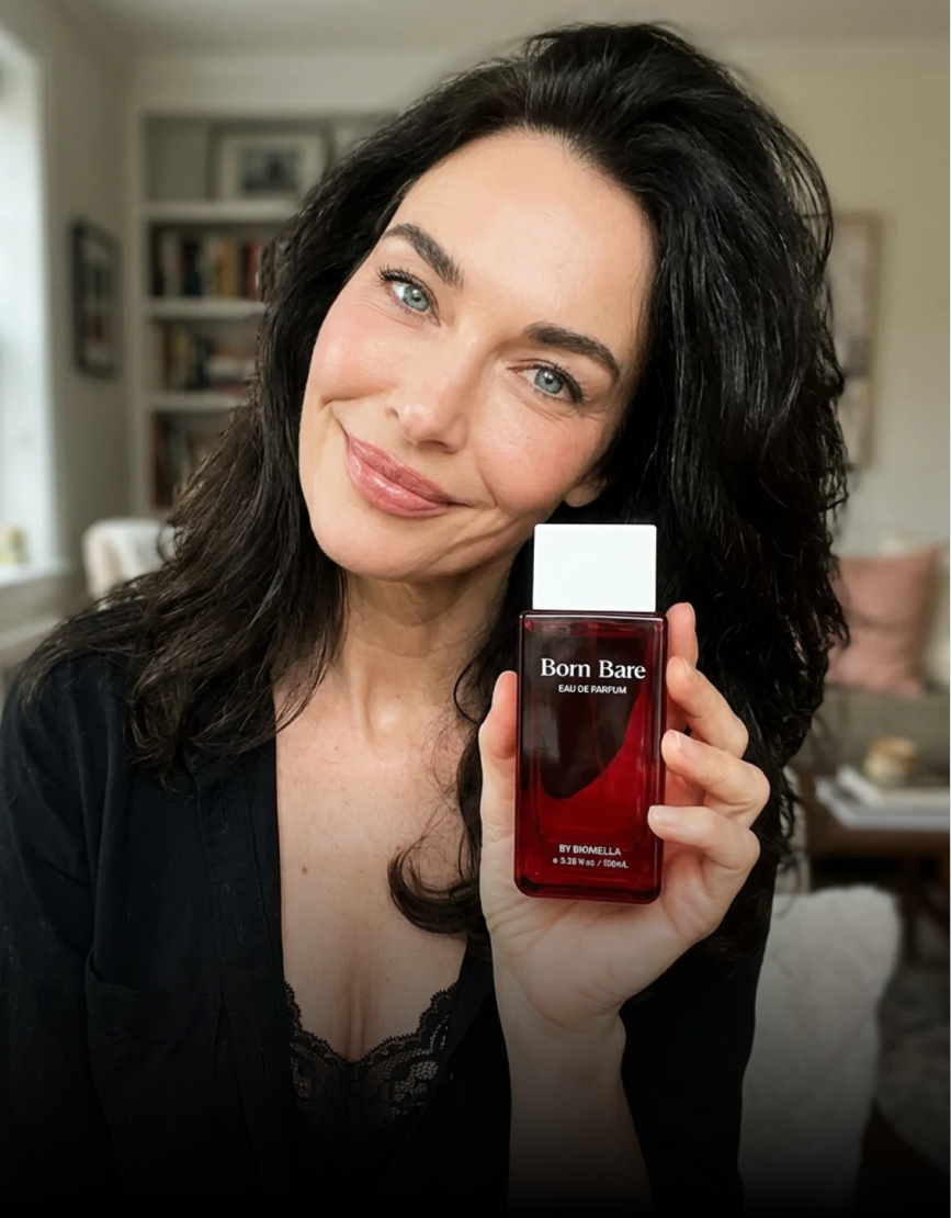 Woman with dark hair holding Biomella Born Bare Eau de Parfum bottle