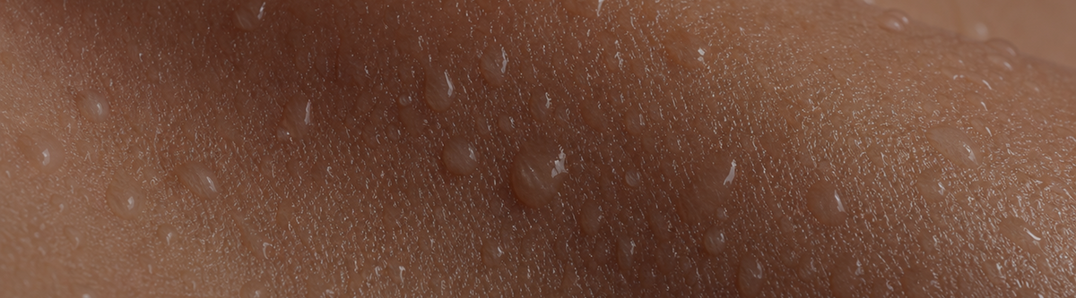 Close-up of hydrated skin texture with water droplets, representing Biomella Advanced Barrier Complex