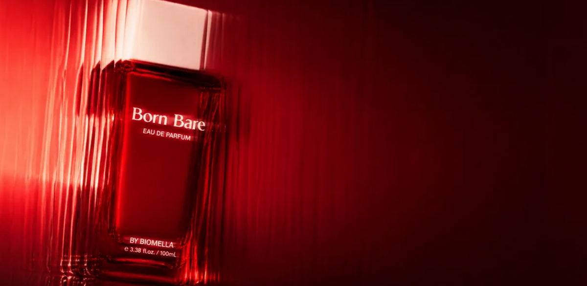 Biomella Born Bare Eau de Parfum red perfume bottle against a deep red background
