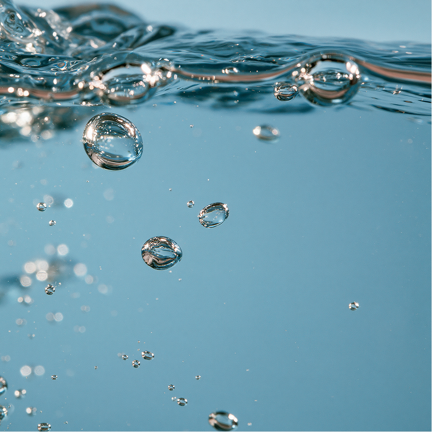 Blue liquid with floating air bubbles representing biomimetic replenishing ingredients