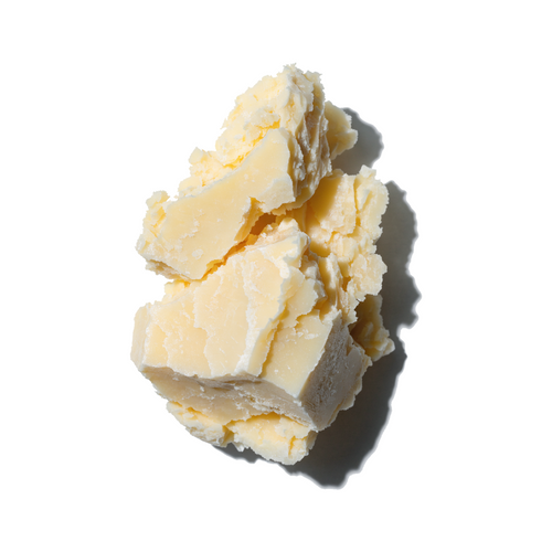 Raw shea butter pieces on a white background