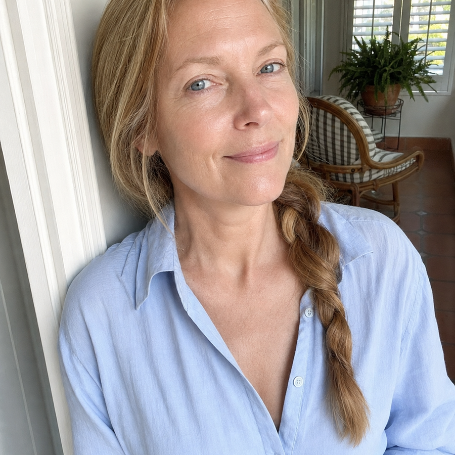 Woman with long blonde braid wearing a light blue shirt