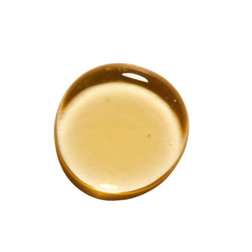 Golden squalane oil droplet on a white background